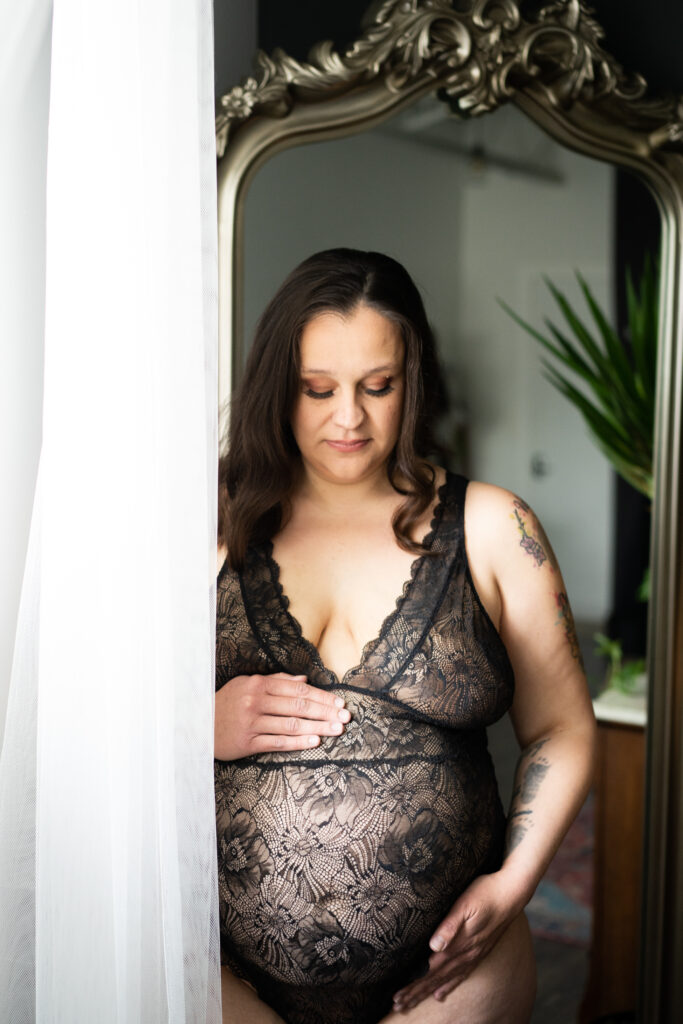 Pregnant woman in lingerie in the boudoir studio.